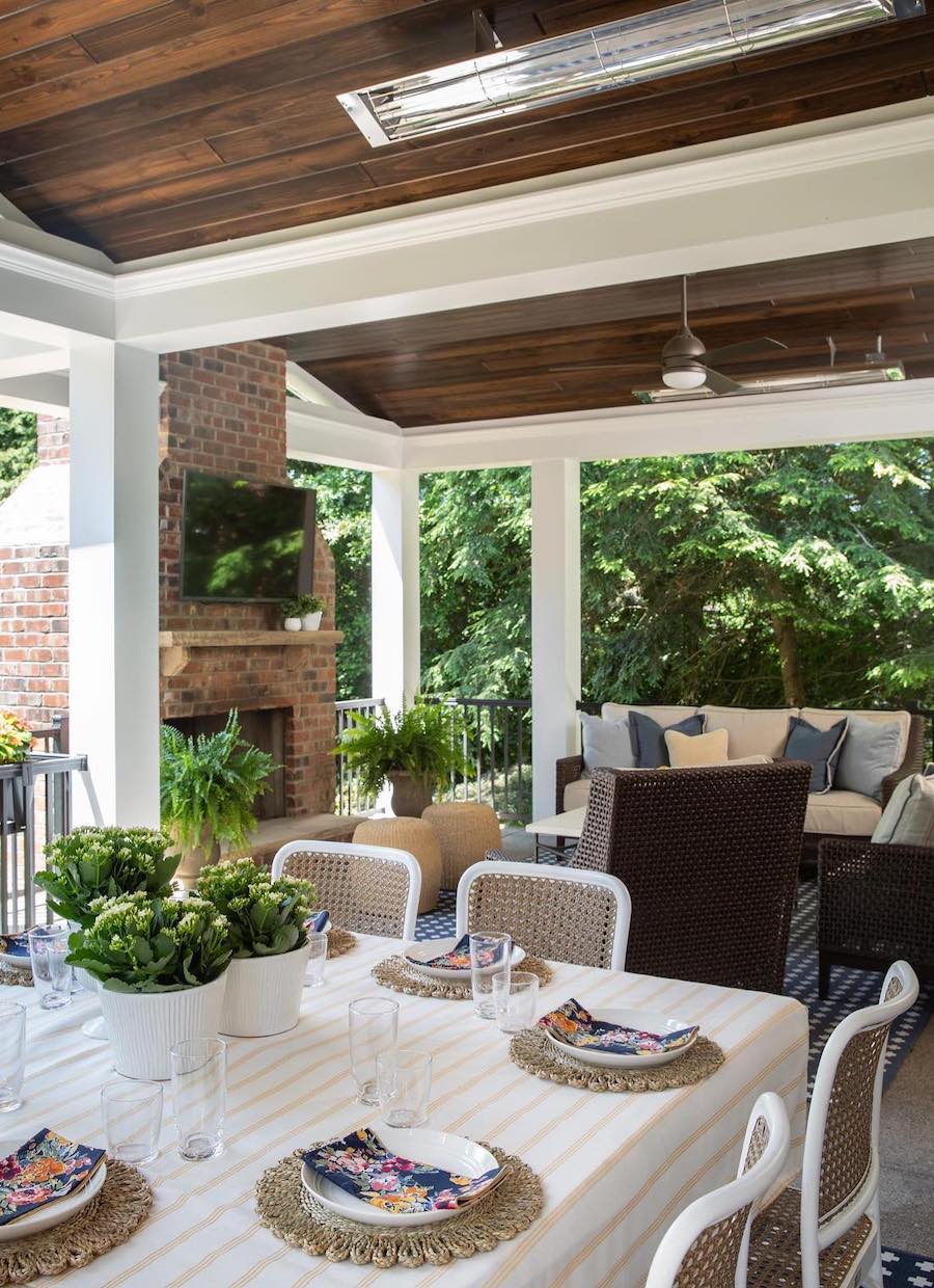 a backyard patio with a fireplace, lounge area, and dining table