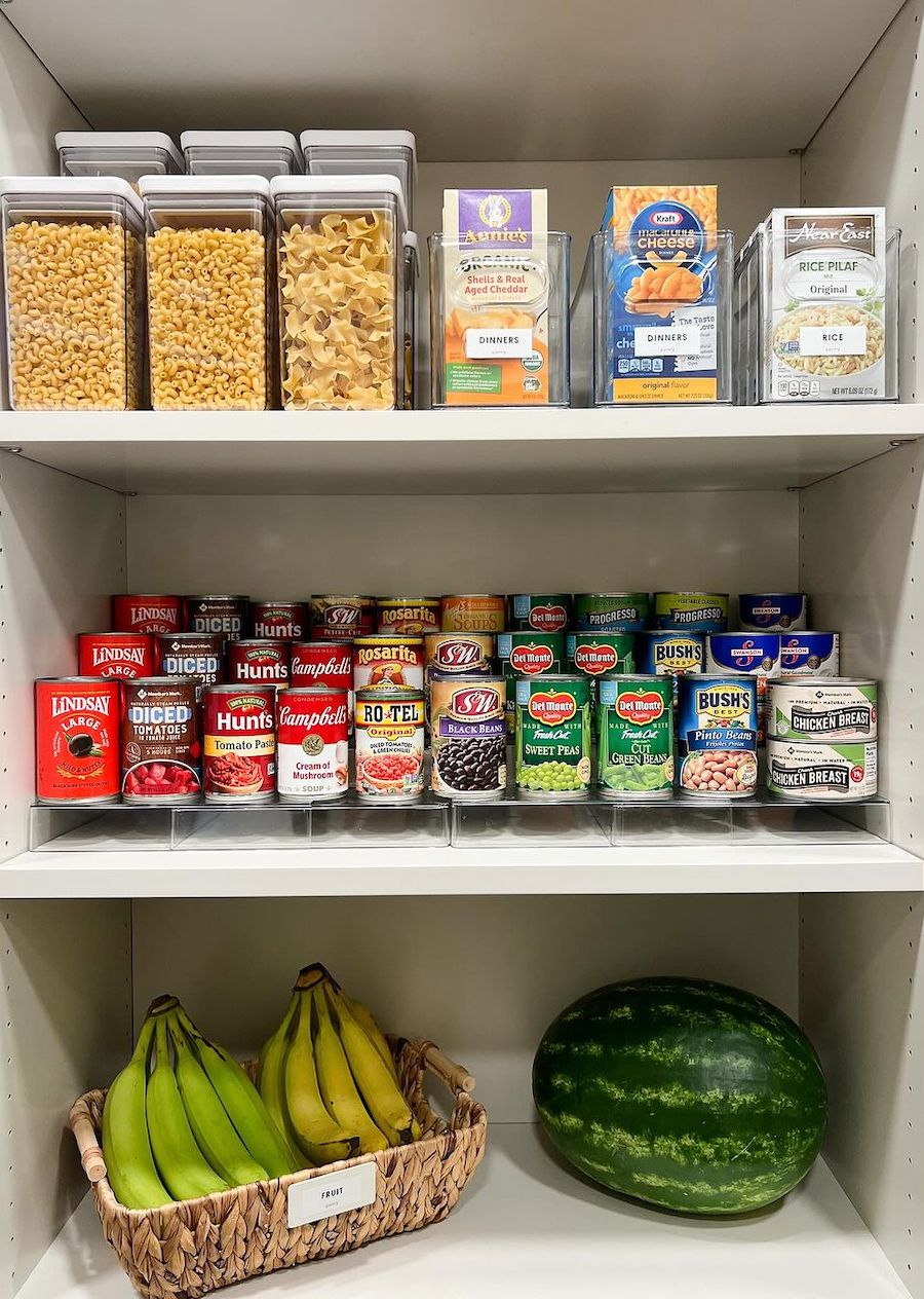 a pantry cabinet with acrylic containers, canned food stands, and produce storage