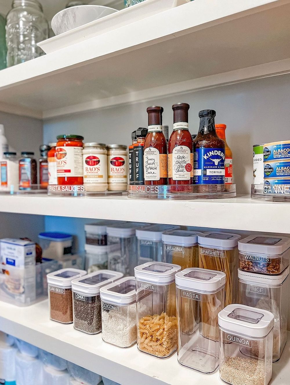 a pantry with built in shelving, acrylic containers and lazy Susan's