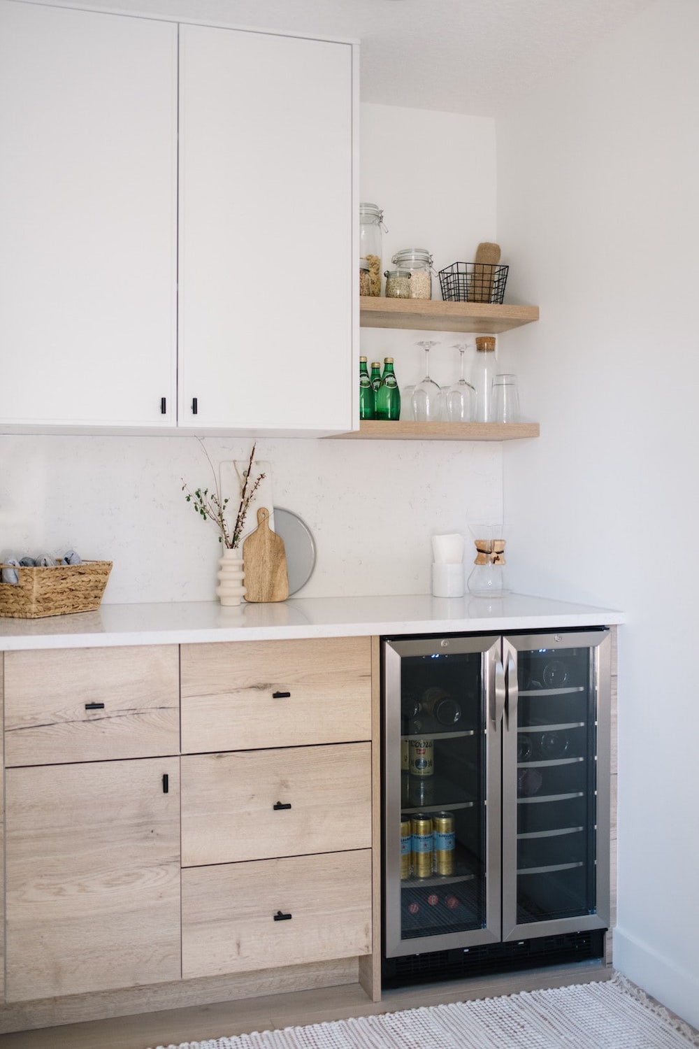 a corner pantry with a mini drink fridge and open shelves